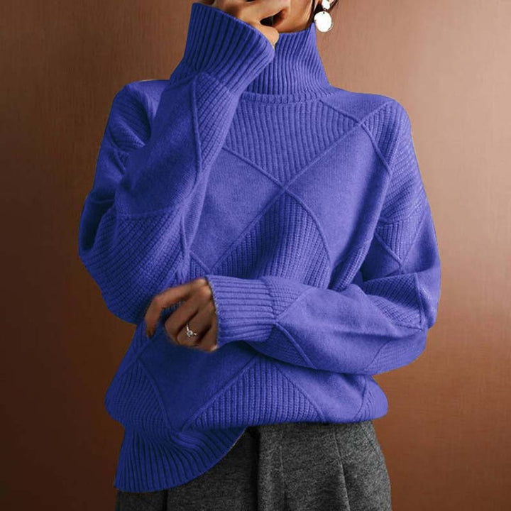 Marisol oversized diamond pattern sweater laid flat with jeans