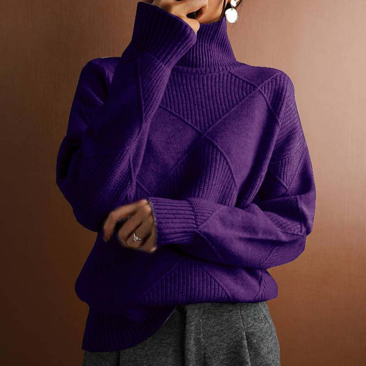 Marisol oversized diamond pattern sweater laid flat with jeans