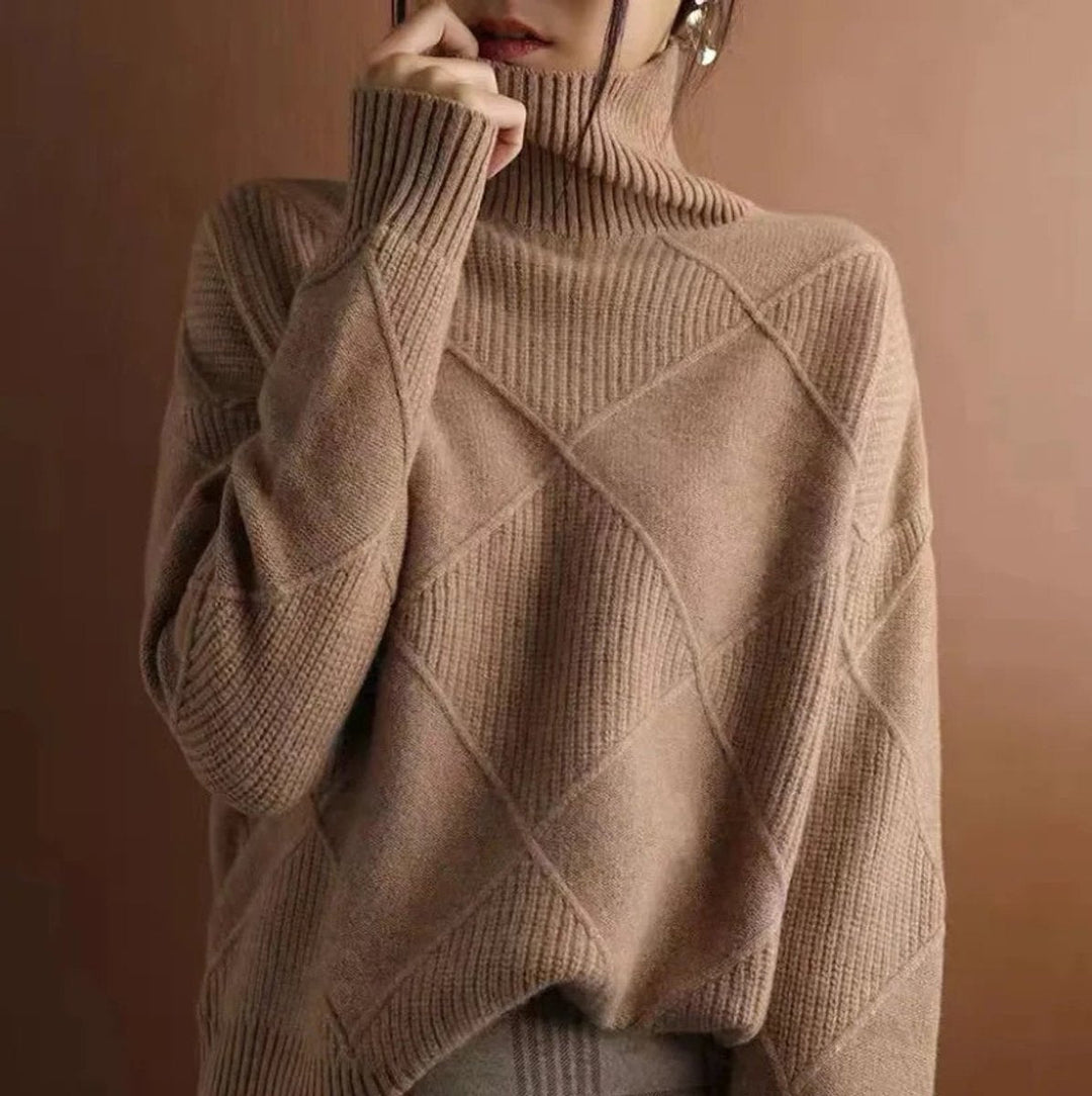 Marisol oversized diamond pattern sweater laid flat with jeans