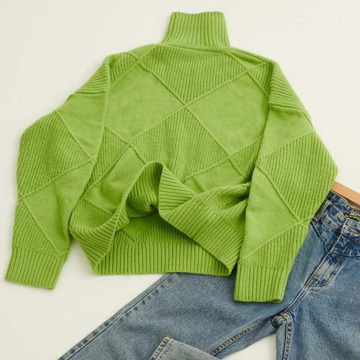 Marisol oversized diamond pattern sweater laid flat with jeans