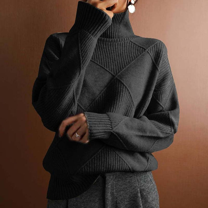 Marisol oversized diamond pattern sweater laid flat with jeans