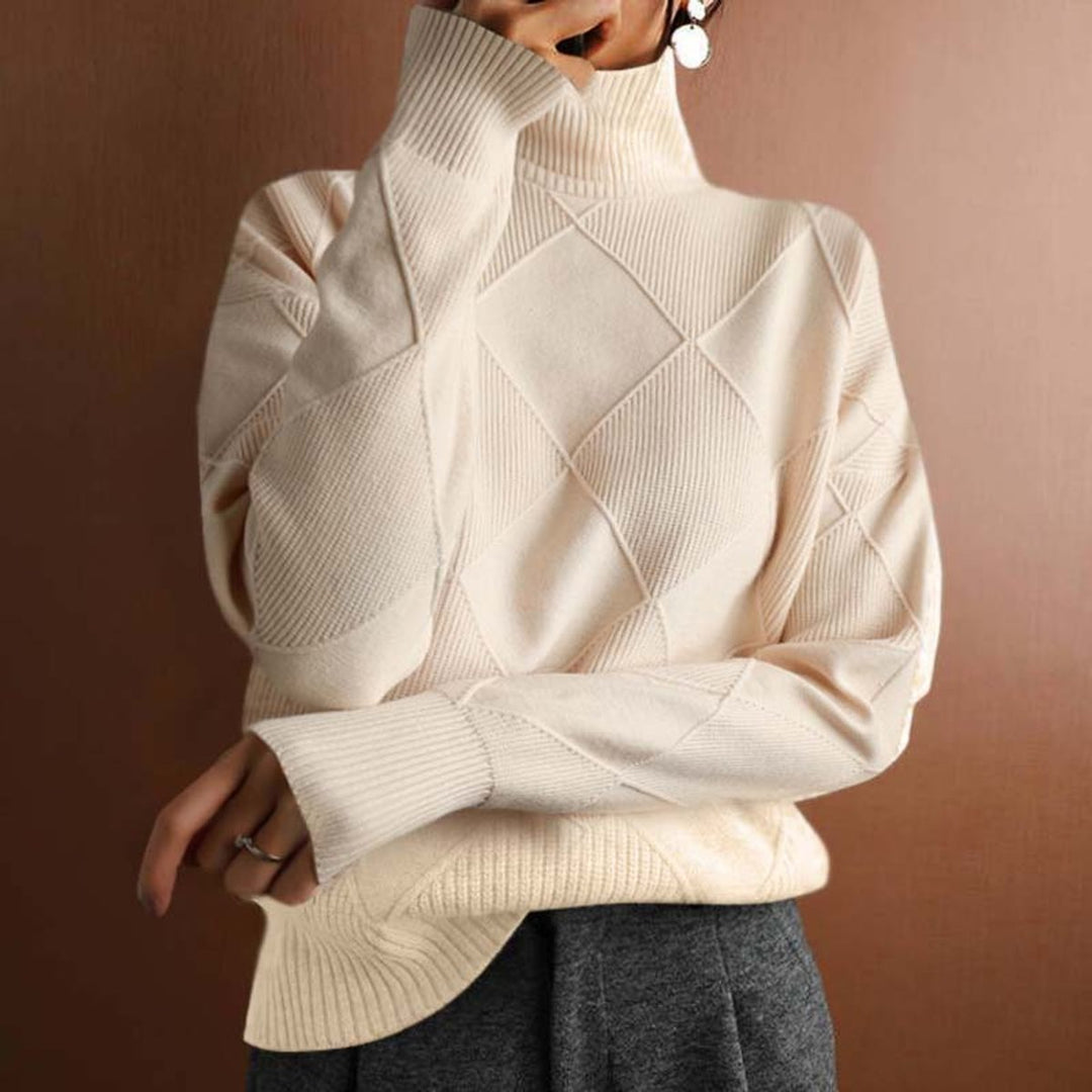Marisol oversized diamond pattern sweater laid flat with jeans