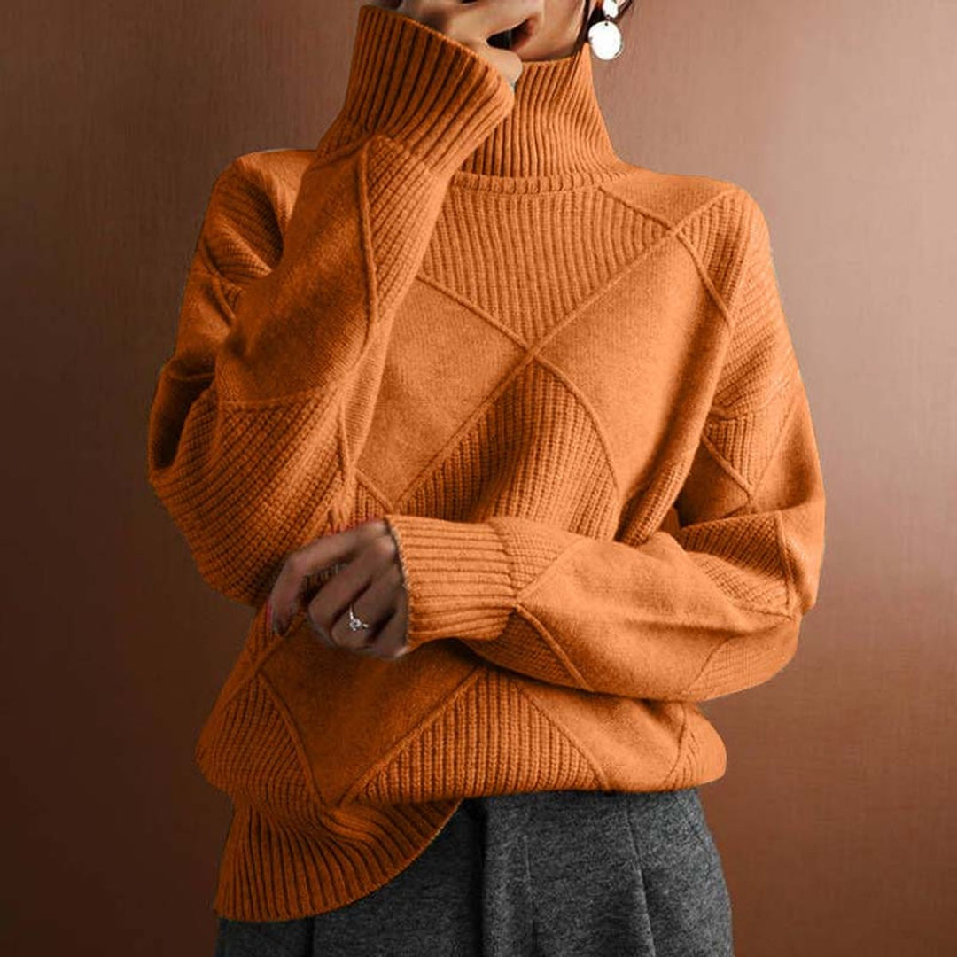 Marisol oversized diamond pattern sweater laid flat with jeans
