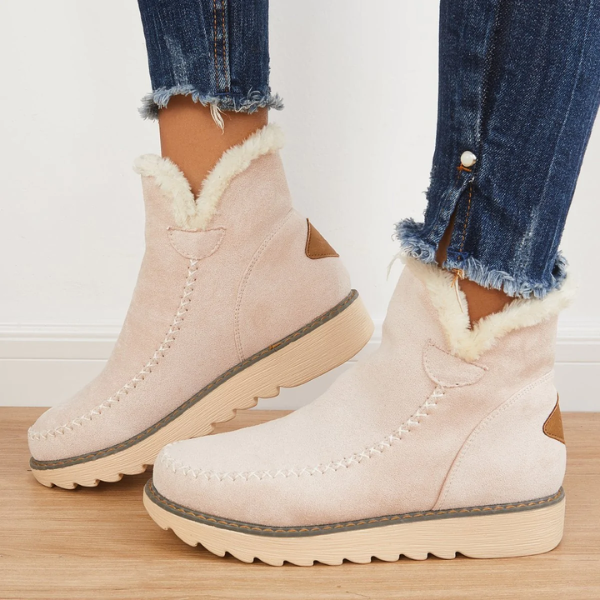 Marisol fur-trim ankle boots in light pink, side view on model