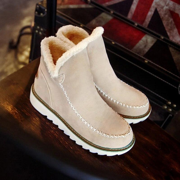 Marisol fur-trim ankle boots in light pink, styled on table