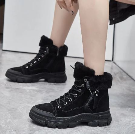 Marisol black fur trim lace-up platform snow boots, side view on model