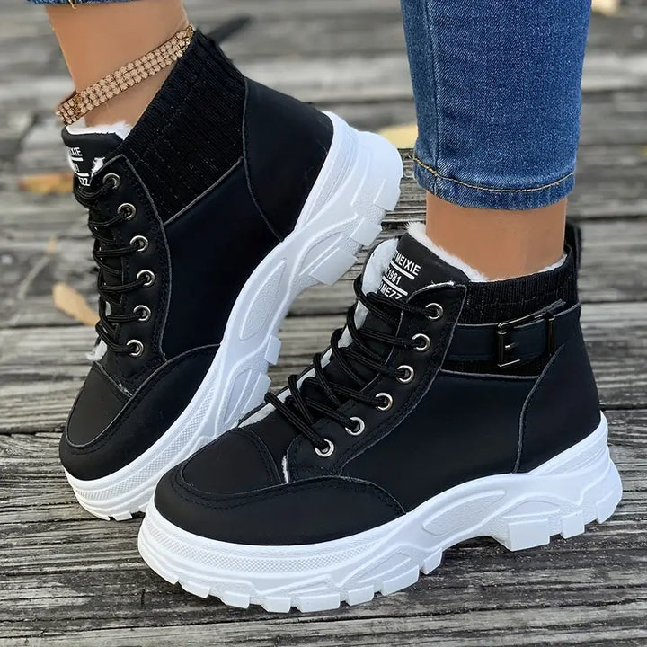 Marissa black lace-up high-top sneaker boots worn with jeans, side view