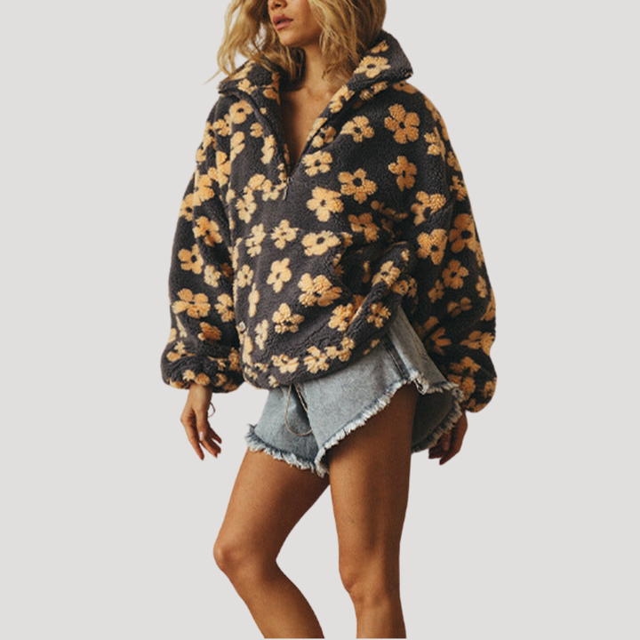 Marlowe floral half-zip sweater in orange floral print, styled with wide-leg pants