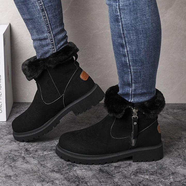 Marlowe fur lined ankle boots in black, side view on model