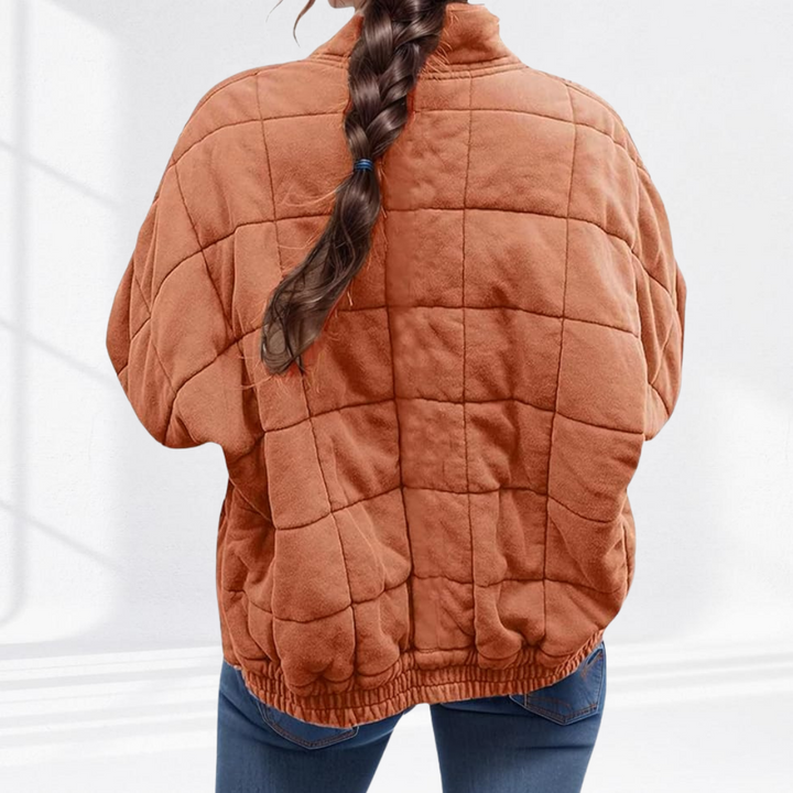 Marlowe quilted zip-up bomber jacket in rust orange, back view showing quilted paneling