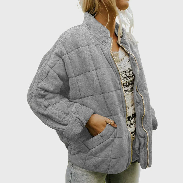Marlowe quilted zip-up bomber jacket in gray, front side view with hand in pocket