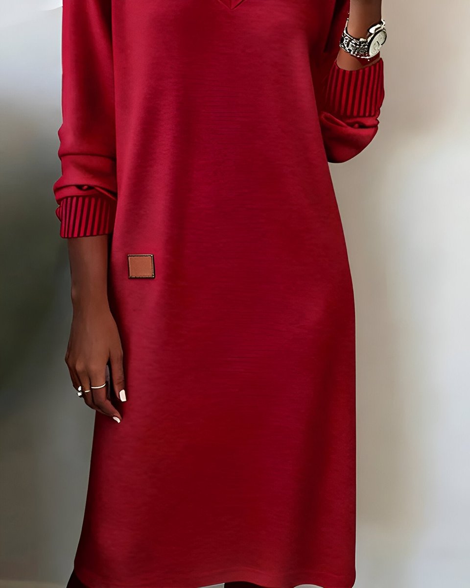Mia red midi dress close-up showing leather patch hem detail