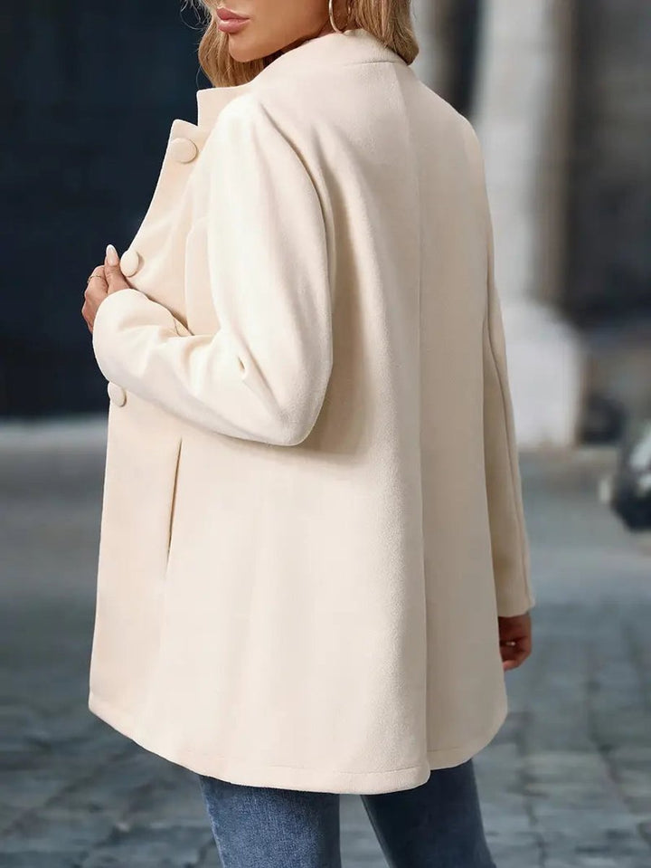 Naomi cream longline blazer coat, close-up front view with hand in pocket