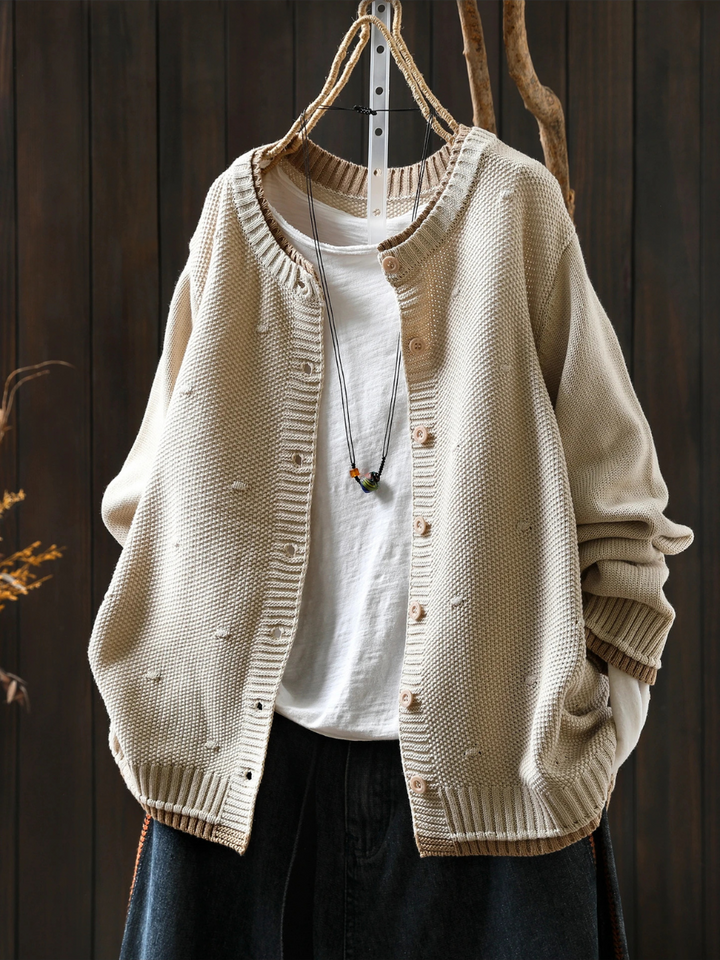 Odette oversized cream knit cardigan buttoned, front view on hanger
