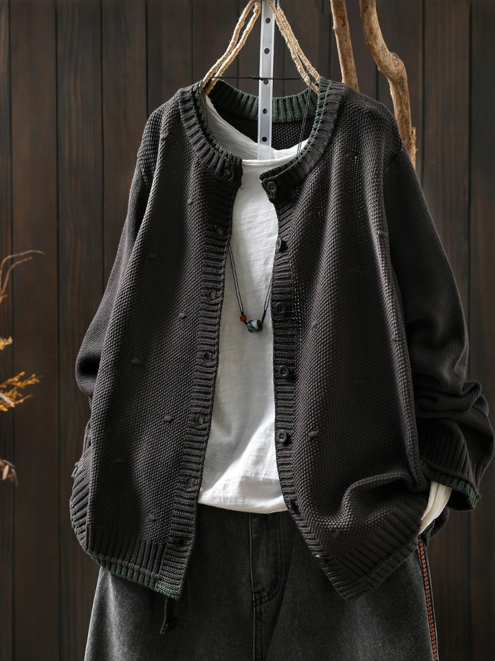 Odette oversized black knit cardigan, front view on hanger