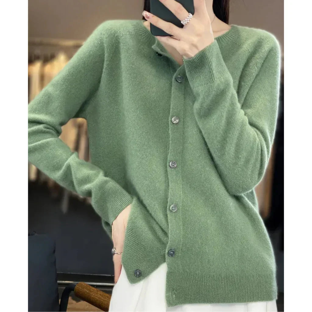Rosalind button down cardigan in green, side view with phone in hand