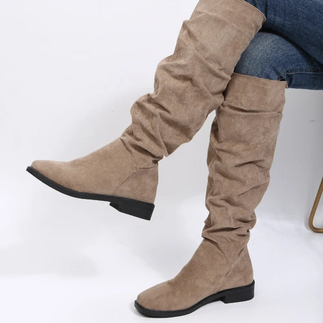 Rosalind slouchy knee high flat boots in khaki, side view on model