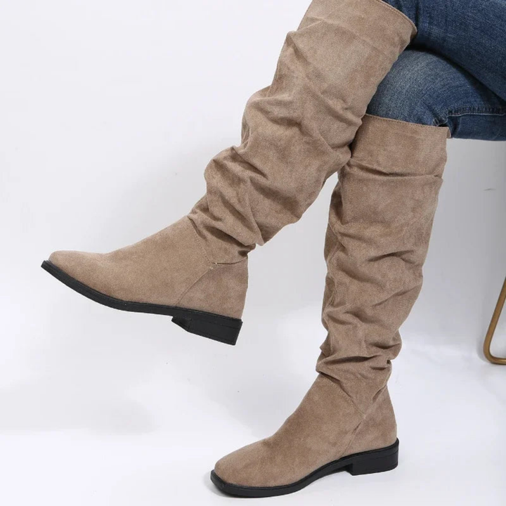 Rosalind slouchy knee high flat boots in khaki, side view on model