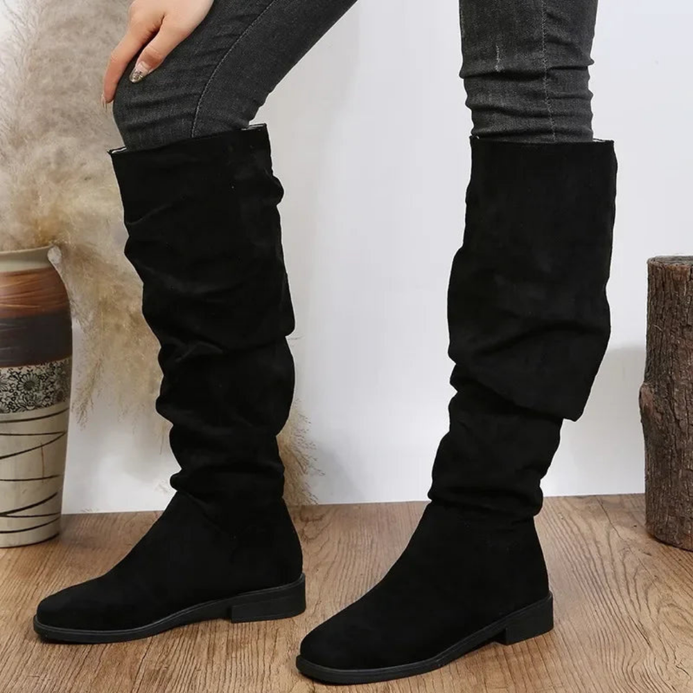 Rosalind slouchy knee high flat boots in black, front view on model