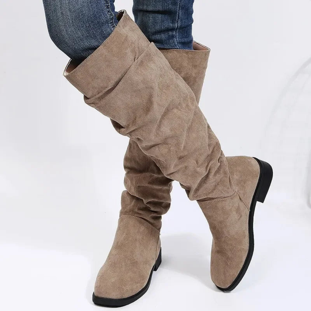 Rosalind slouchy knee high flat boots in khaki, close-up crossed leg view