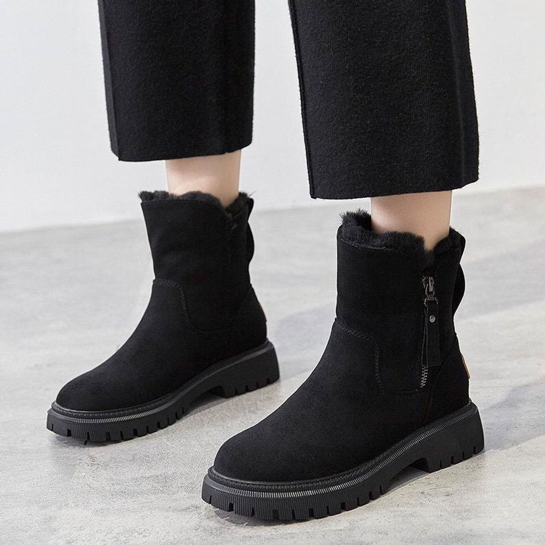 Rosalyn slip-on ankle boots worn on model with black pants, front view