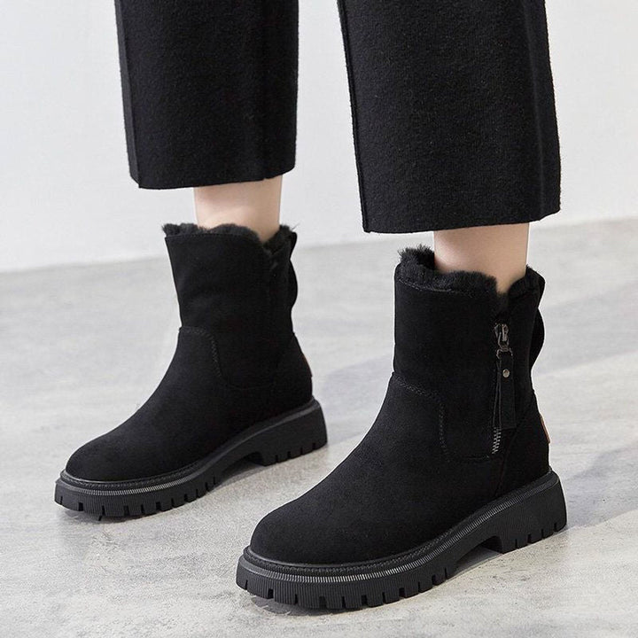 Rosalyn slip-on ankle boots worn on model with black pants, front view