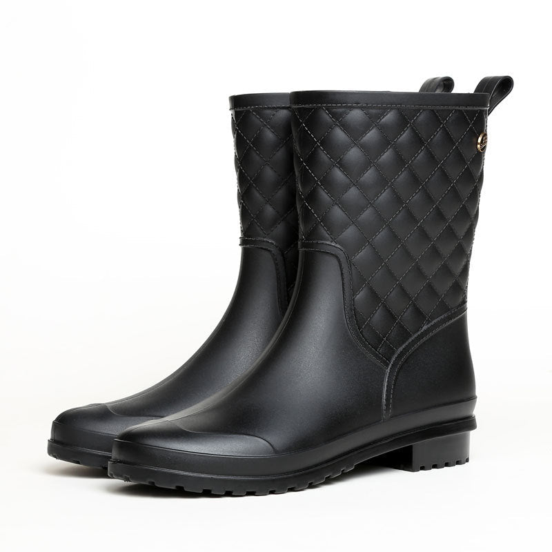 Rosamund quilted rain boots in black, angled pair view on white background