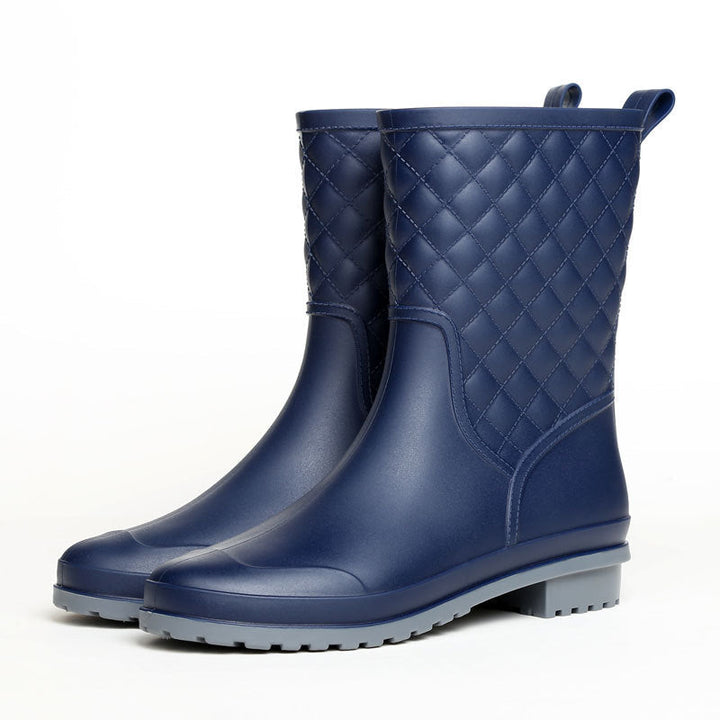 Rosamund quilted rain boots in black, angled pair view on white background