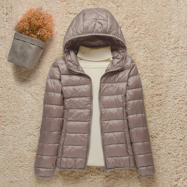 Sabina hooded packable puffer jacket in taupe, front view unzipped over cream sweater