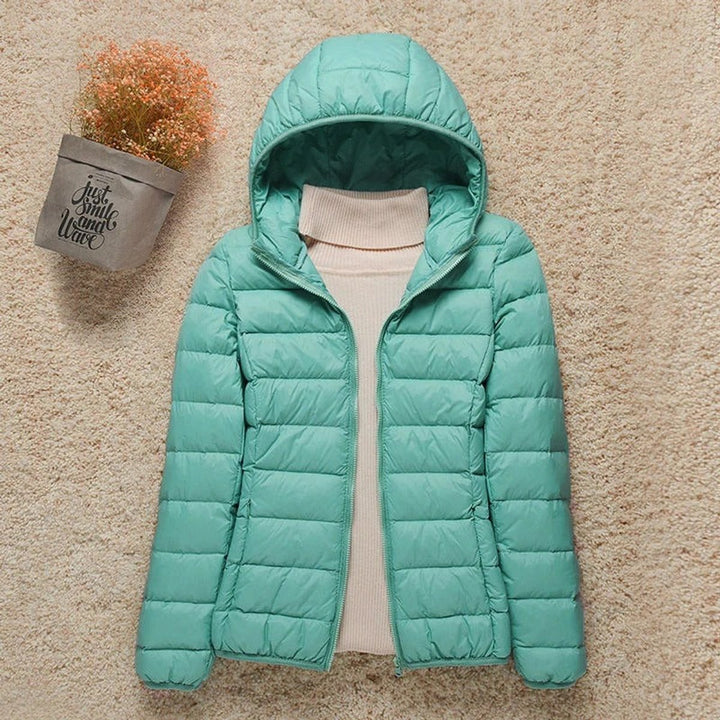 Sabina hooded packable puffer jacket in turquoise, front view with hood up
