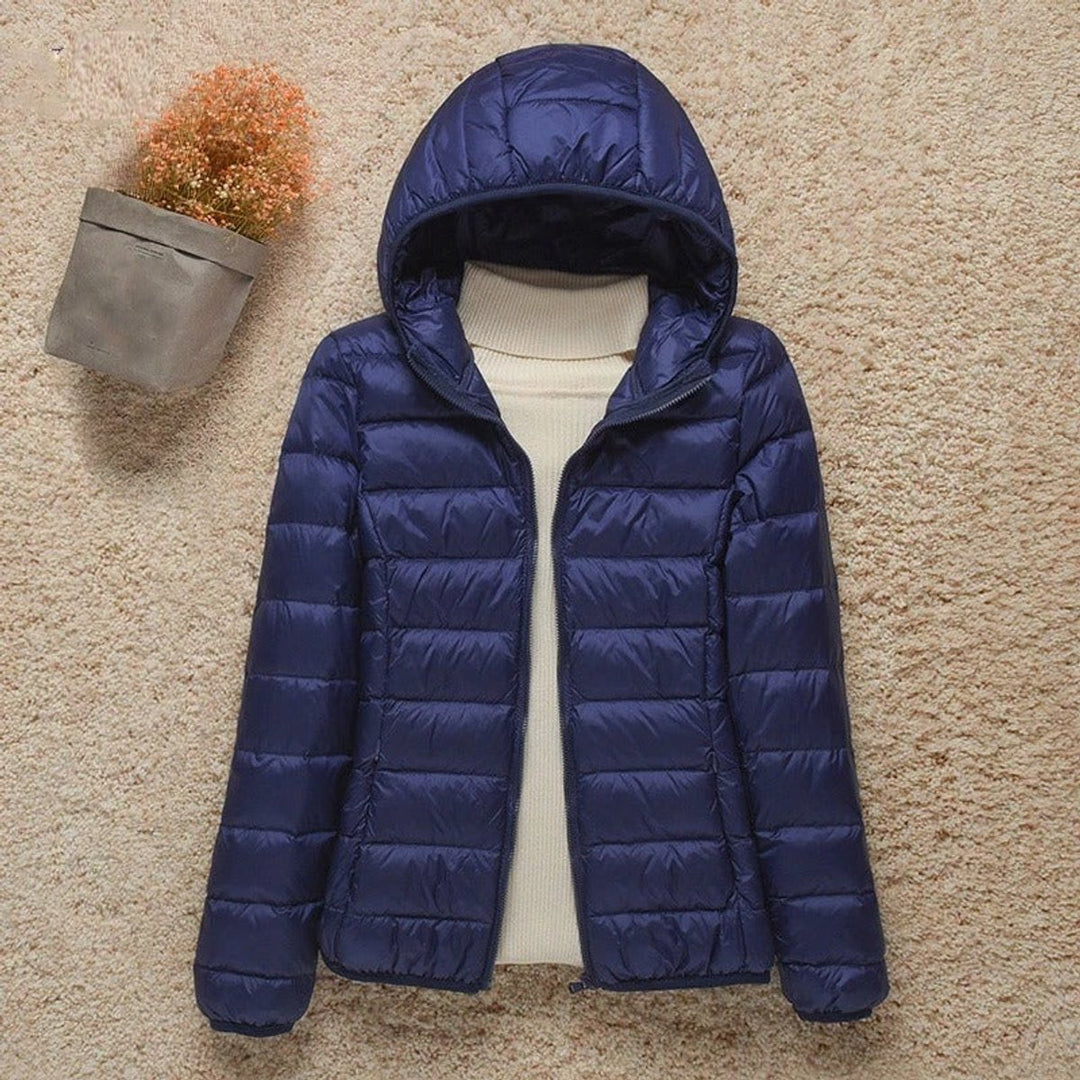 Sabina hooded packable puffer jacket in navy blue, front view with hood up