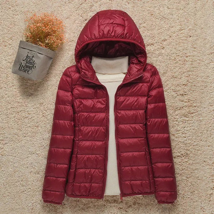 Sabina hooded packable puffer jacket in burgundy, front view with hood up