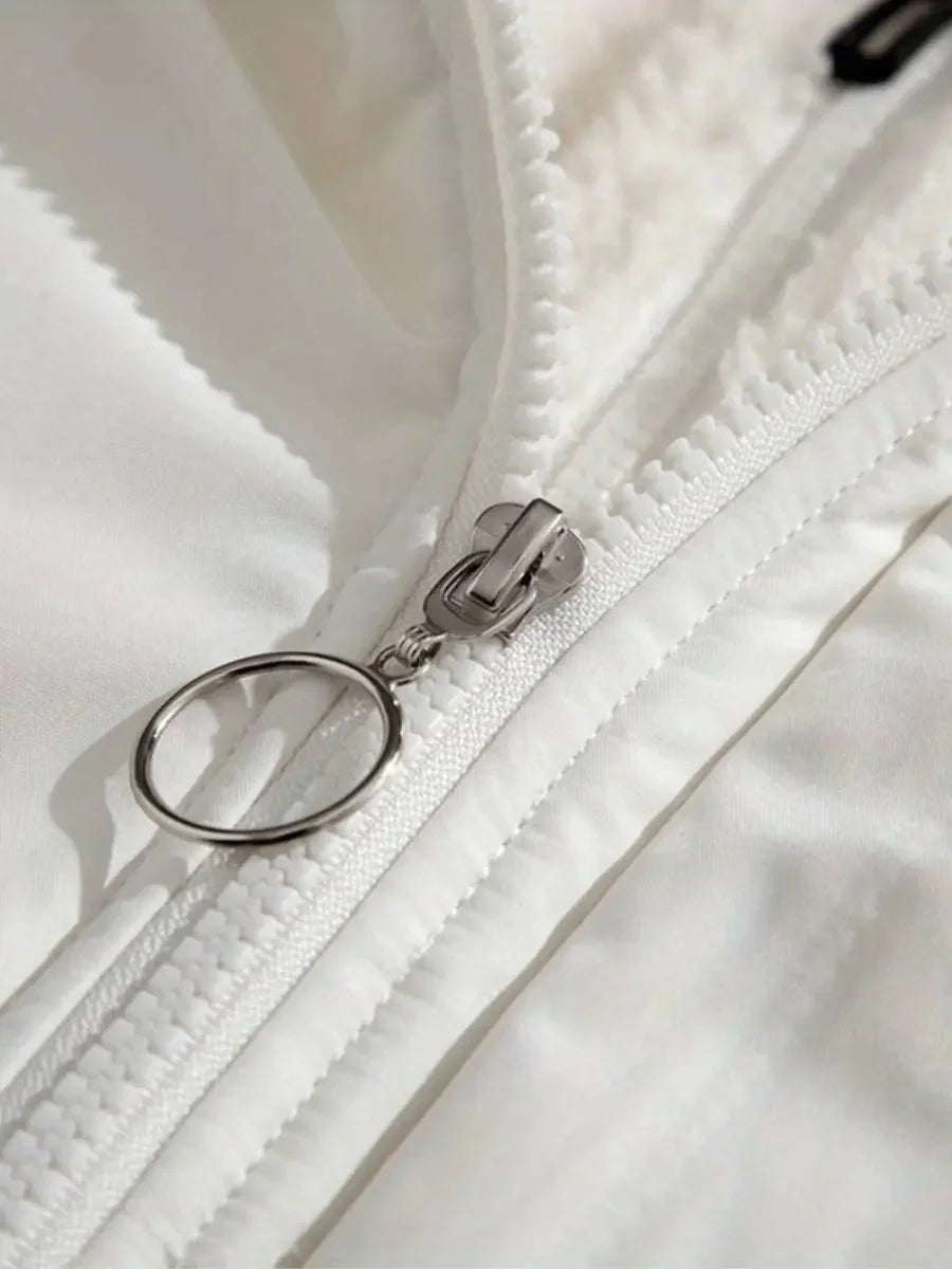 Close-up of white puffer jacket zipper with ring pull