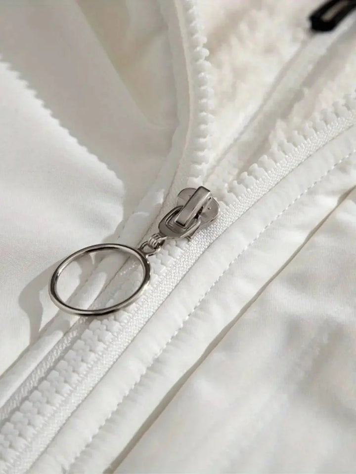 Close-up of white puffer jacket zipper with ring pull