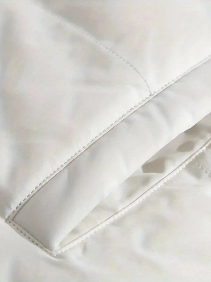 Close-up of white puffer jacket pocket stitching detail