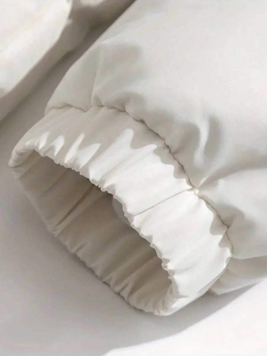 Close-up of white puffer jacket elastic cuff detail