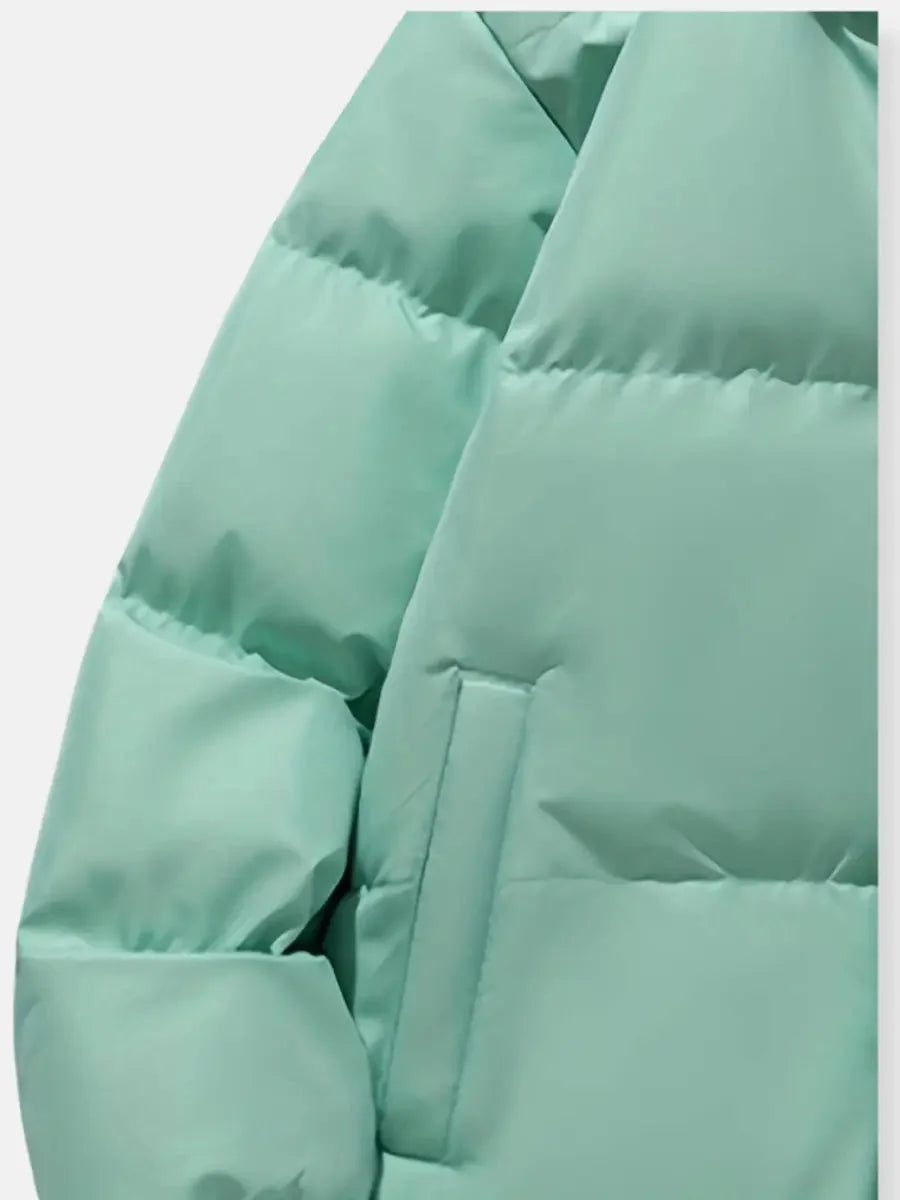 Close-up of mint green puffer jacket pocket and quilting detail