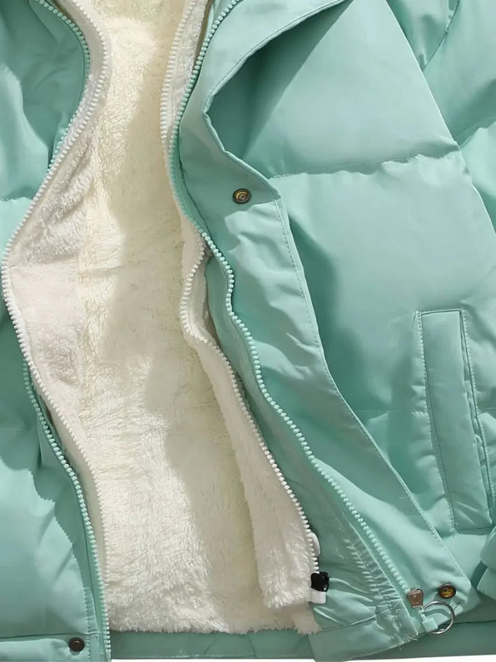 Close-up of mint green puffer jacket interior lining and zipper