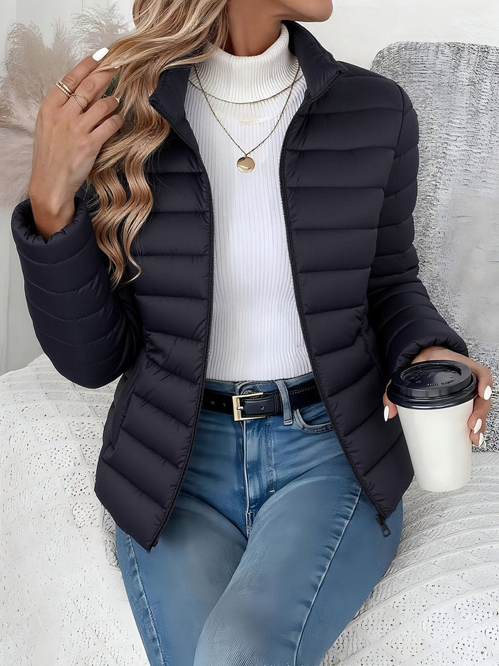 Sienna black quilted puffer jacket, front view seated