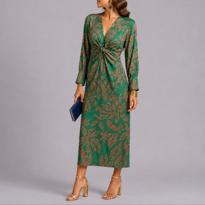 Sophie floral twist front midi dress in green, side view with navy clutch
