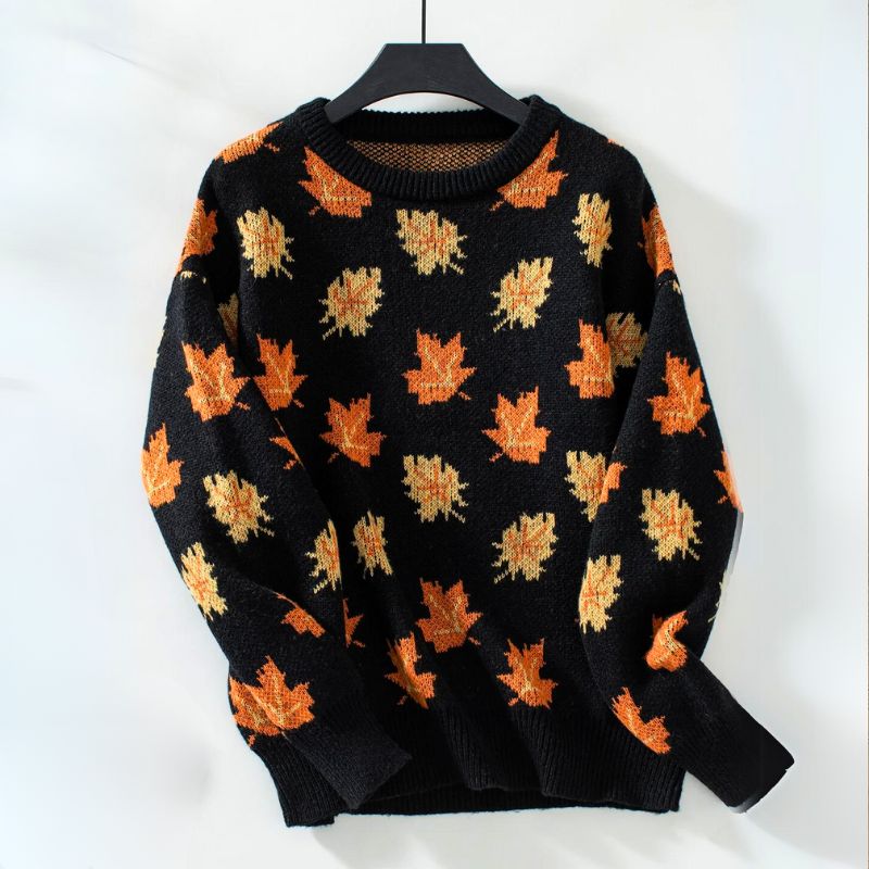 Sylvie leaf print sweater in black colorway on hanger
