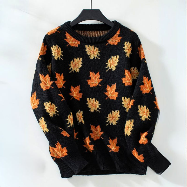 Sylvie leaf print sweater in black colorway on hanger