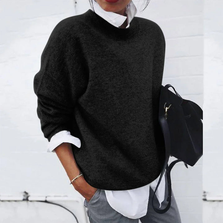 Tamsin black mock neck knit sweater, front view with backpack