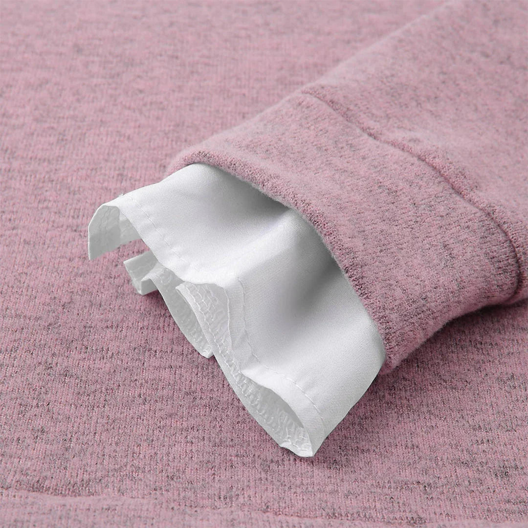 Close-up of pink knit sweater ribbed cuff with white shirt sleeve