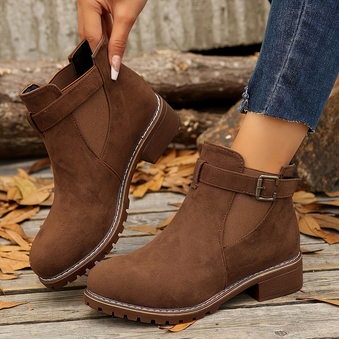 Close-up side view of brown Vivienne Chelsea boot with buckle strap
