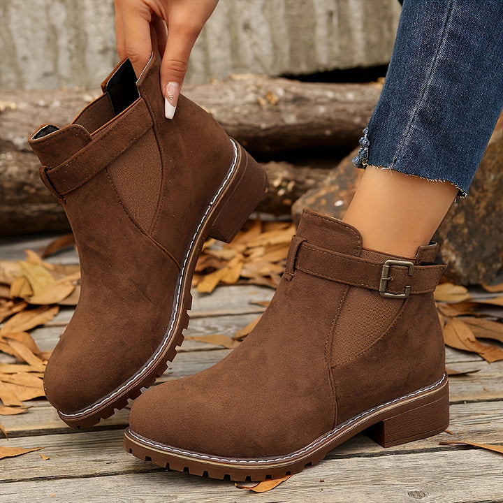 Close-up side view of brown Vivienne Chelsea boot with buckle strap