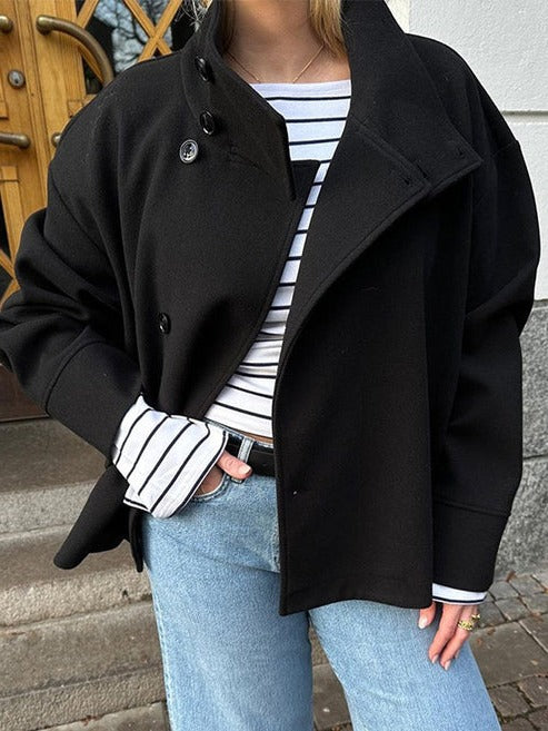 Vivienne double breasted short coat in black worn open over striped top, front view