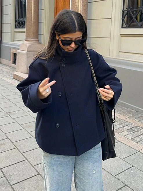 Vivienne double breasted short coat in navy worn buttoned with stand collar, front view