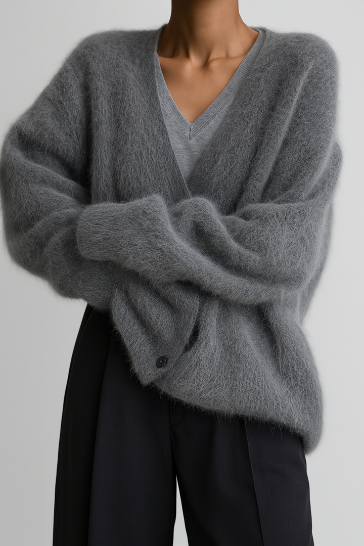 Vivienne fuzzy V-neck cardigan with arms crossed, close-up front view in charcoal grey