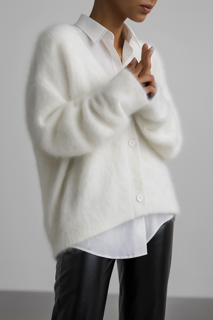 Vivienne fuzzy V-neck button down cardigan layered over a white shirt